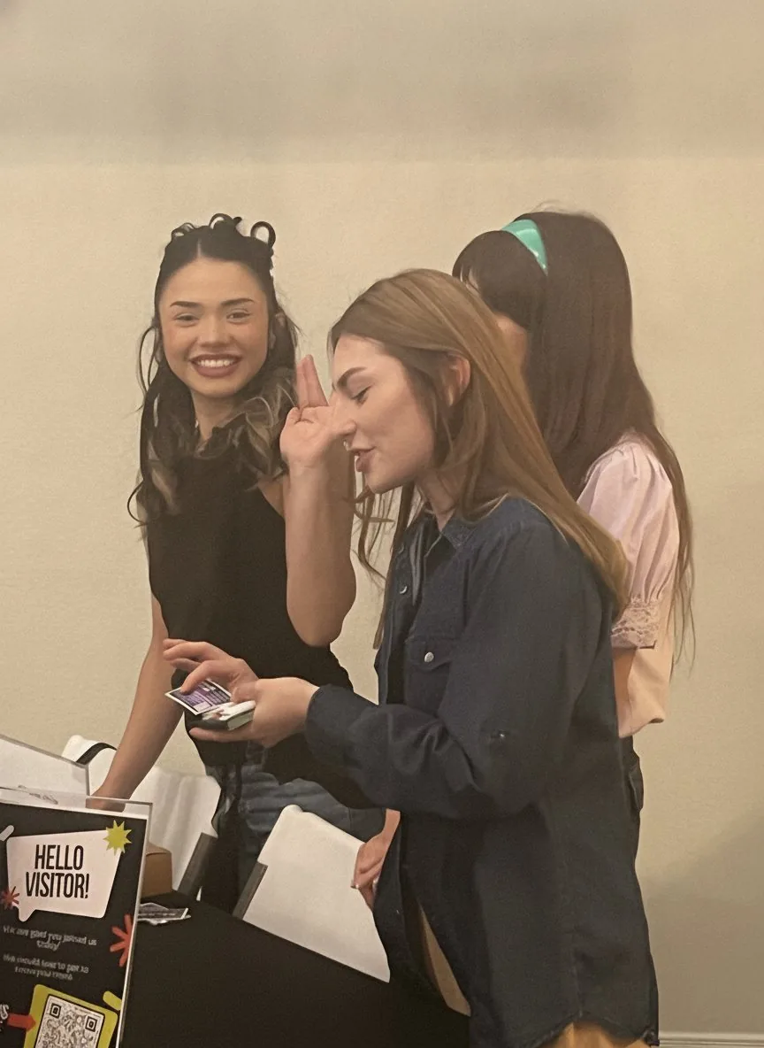 Smiling greeters at the Hello Visitor welcome desk