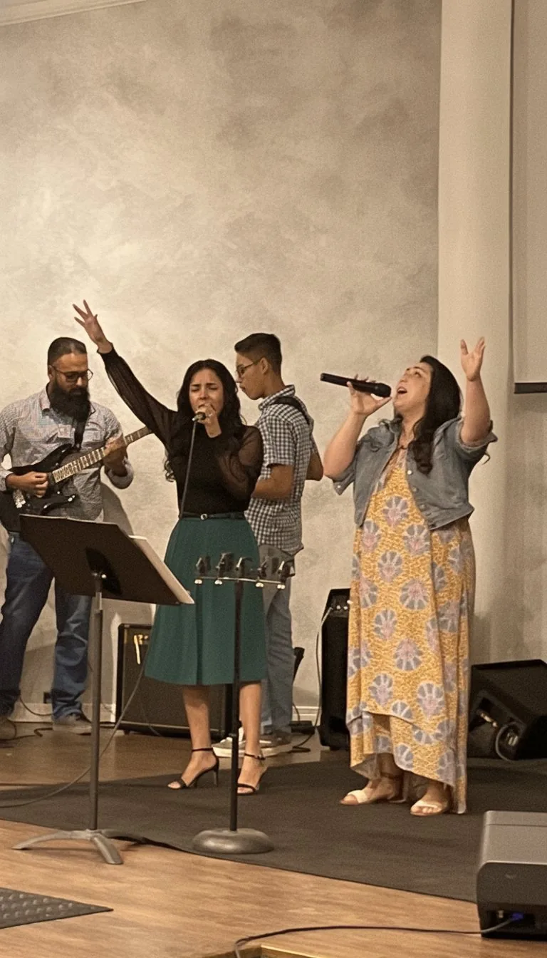The worship team singing with hands raised